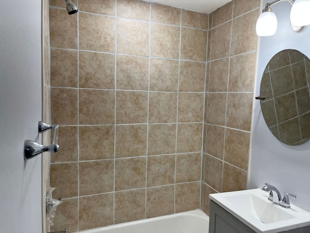 bathroom featuring vanity and tiled shower / bath combo