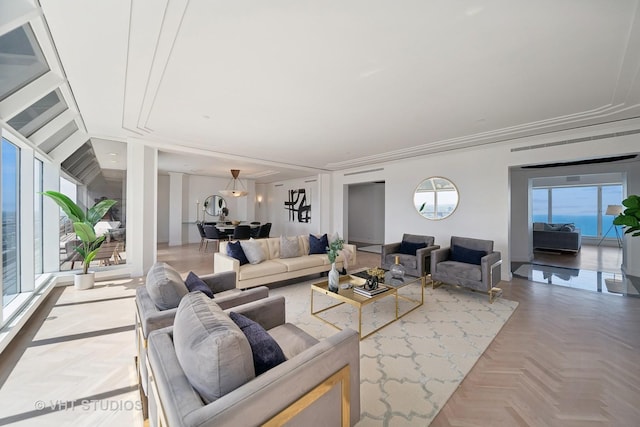 living room with parquet flooring, a wealth of natural light, and crown molding