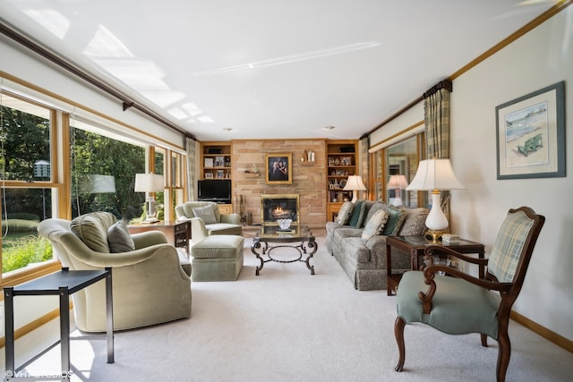 carpeted living room featuring a stone fireplace, crown molding, and built in shelves