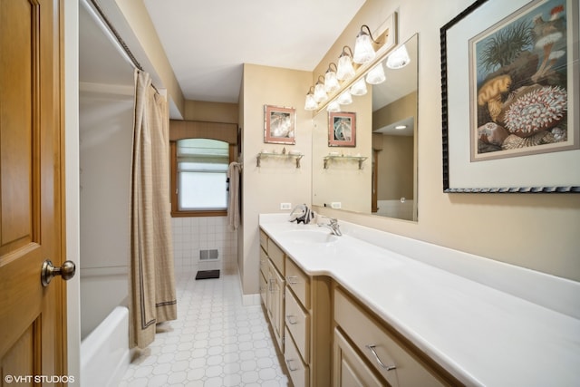 bathroom featuring vanity, tile patterned floors, and shower / tub combo