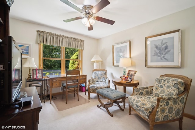 sitting room with carpet and ceiling fan