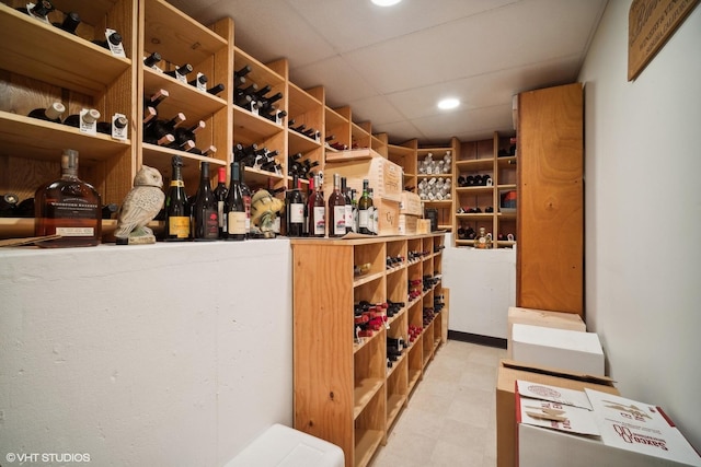 wine cellar featuring tile patterned floors and a drop ceiling