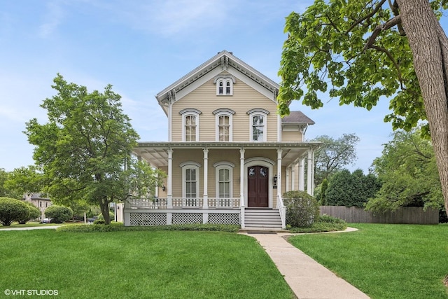 view of front of house with a porch and a front lawn