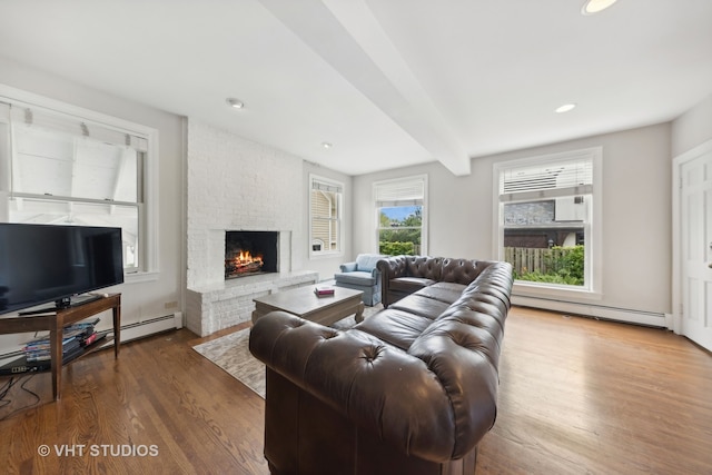 living room featuring beam ceiling, a baseboard radiator, a brick fireplace, and dark wood-type flooring