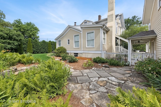 view of home's exterior featuring ceiling fan and a patio