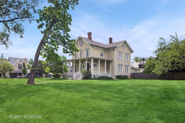 back of house featuring a porch and a yard