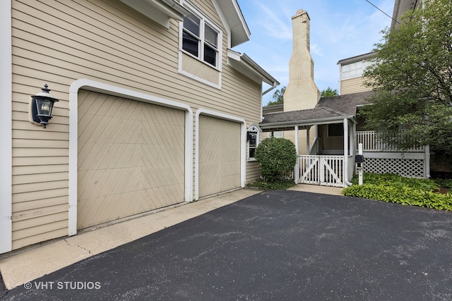 exterior space with a porch and a garage