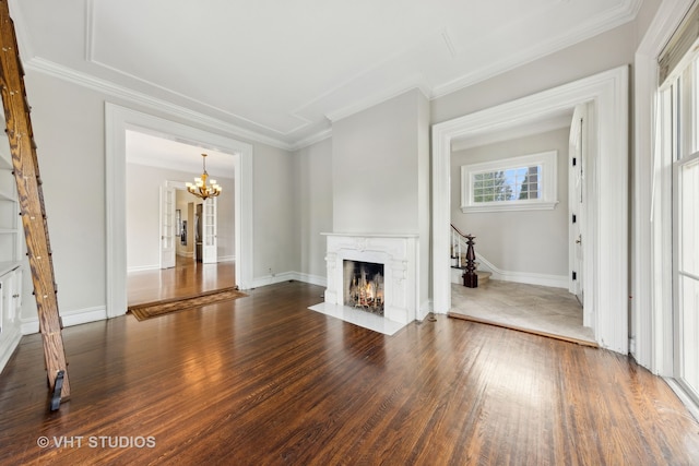 unfurnished living room with ornamental molding, a fireplace, dark wood-type flooring, and an inviting chandelier