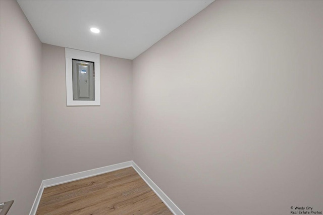 empty room with electric panel and light wood-type flooring