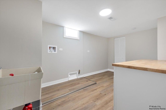 laundry room featuring hookup for a washing machine and light wood-type flooring