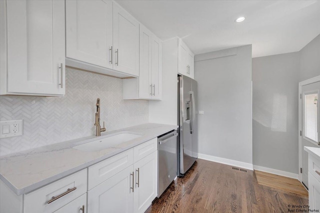 kitchen with appliances with stainless steel finishes, white cabinetry, and sink