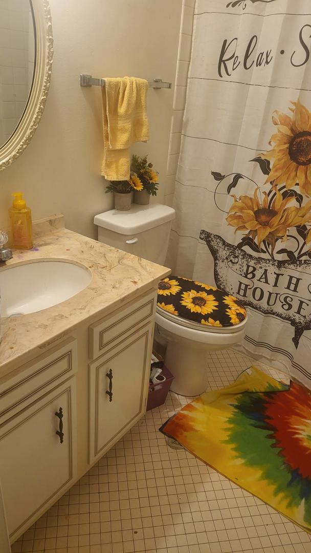 bathroom featuring tile patterned flooring, vanity, and toilet