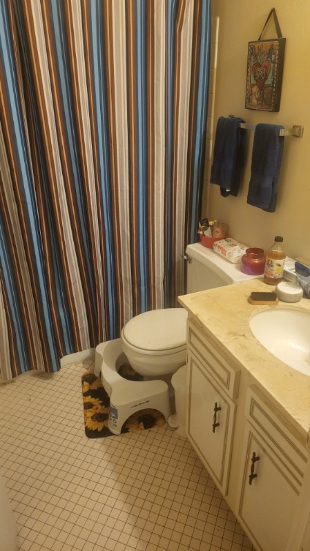 bathroom featuring tile patterned flooring, vanity, toilet, and a shower with curtain