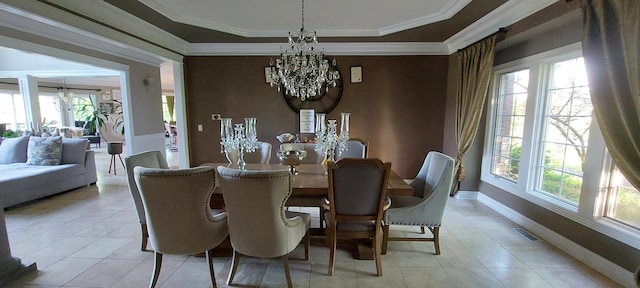 tiled dining area featuring ornamental molding and an inviting chandelier