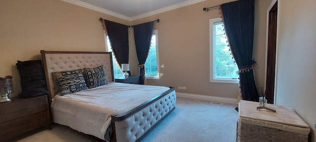 bedroom with ornamental molding and carpet flooring