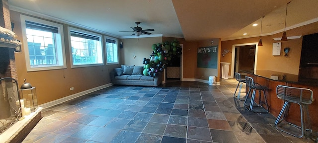 interior space featuring ornamental molding, ceiling fan, and dark tile floors