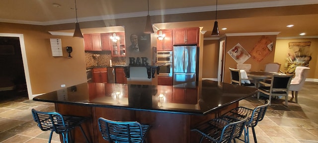 kitchen featuring appliances with stainless steel finishes, tasteful backsplash, light tile floors, and a kitchen bar