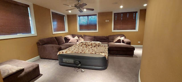 cinema room featuring carpet flooring and ceiling fan