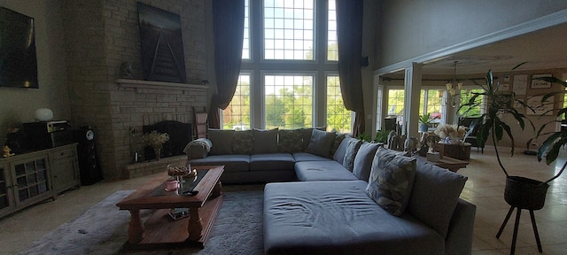 living room featuring a stone fireplace and tile floors