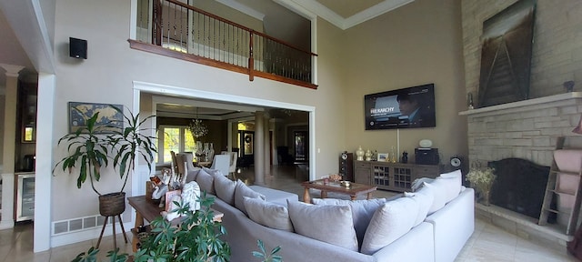 tiled living room with ornamental molding, a fireplace, beverage cooler, a towering ceiling, and a notable chandelier