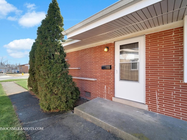 entrance to property with crawl space and brick siding