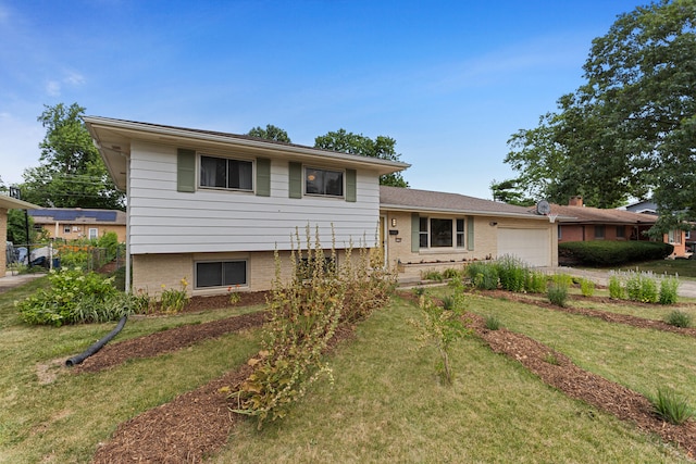 split level home featuring a garage and a front lawn