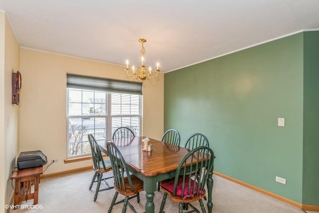 carpeted dining space with crown molding and a notable chandelier