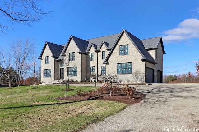 view of front of property with a front lawn and a garage