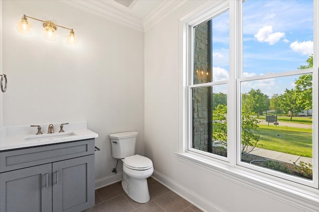 bathroom with tile patterned floors, toilet, vanity, and ornamental molding