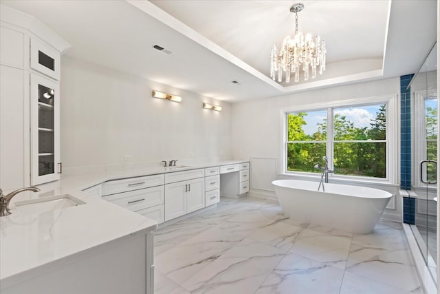 bathroom with vanity, shower with separate bathtub, and a notable chandelier