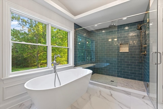 bathroom featuring separate shower and tub