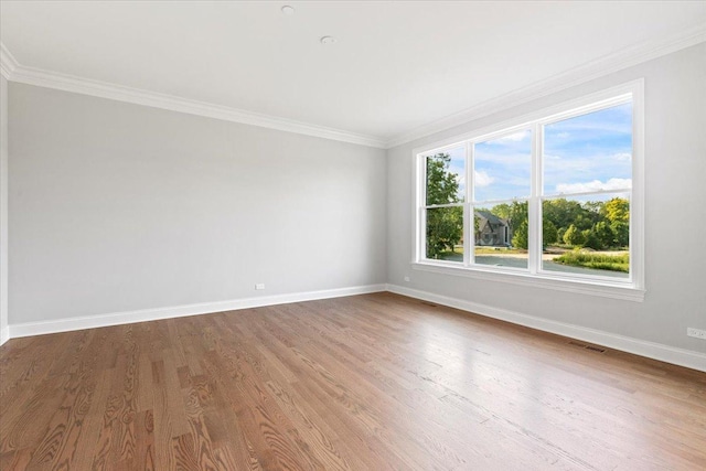 unfurnished room with hardwood / wood-style floors and ornamental molding