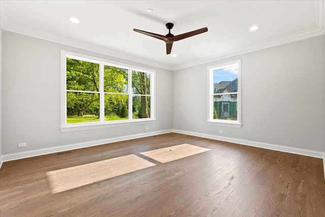 unfurnished room featuring ceiling fan, dark wood-type flooring, and ornamental molding