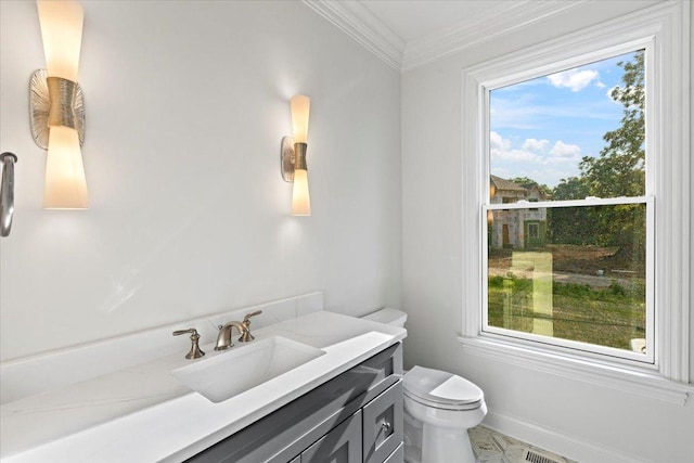 bathroom featuring vanity, toilet, and ornamental molding