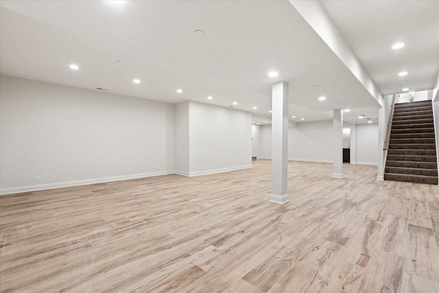 basement with light hardwood / wood-style floors