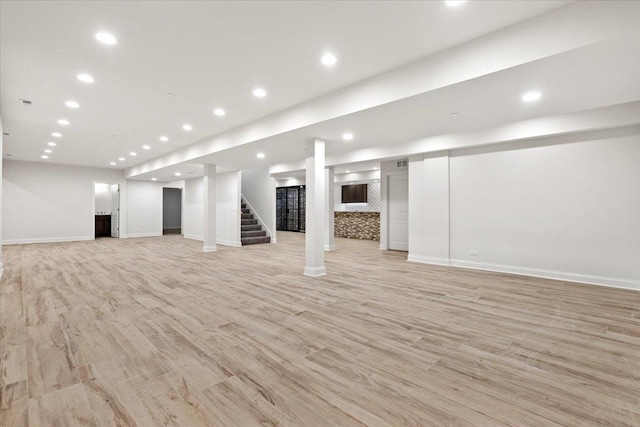 basement with light hardwood / wood-style floors