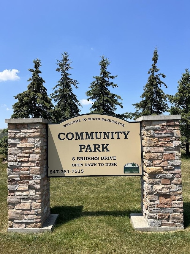 community sign featuring a yard