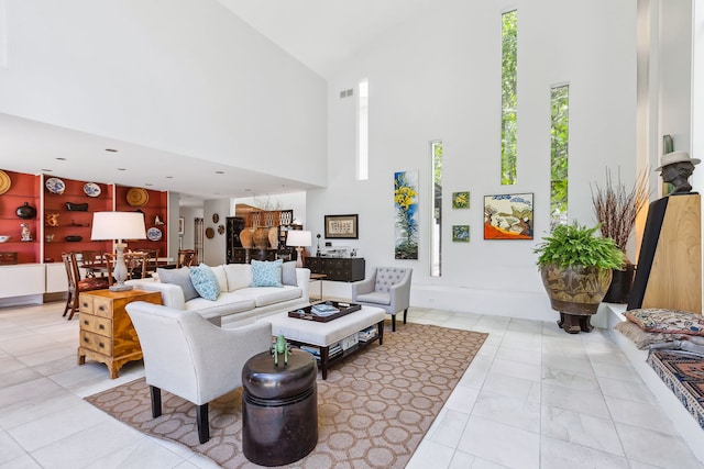 living room featuring a high ceiling and light tile floors