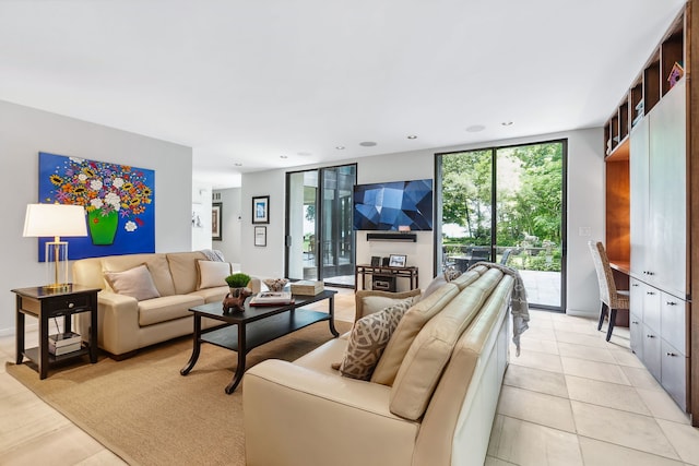 living room featuring floor to ceiling windows and light tile patterned floors
