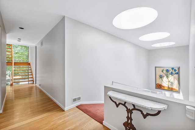 hall featuring expansive windows and light wood-type flooring