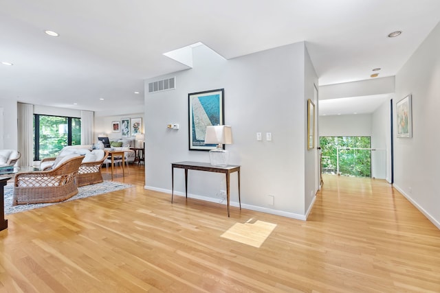 hallway with light hardwood / wood-style floors