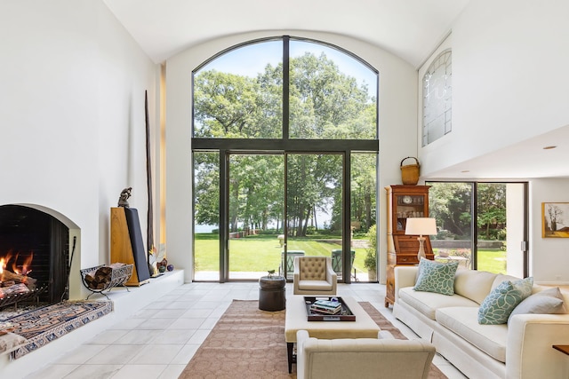 tiled living room with a towering ceiling