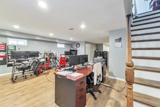 home office with light hardwood / wood-style floors