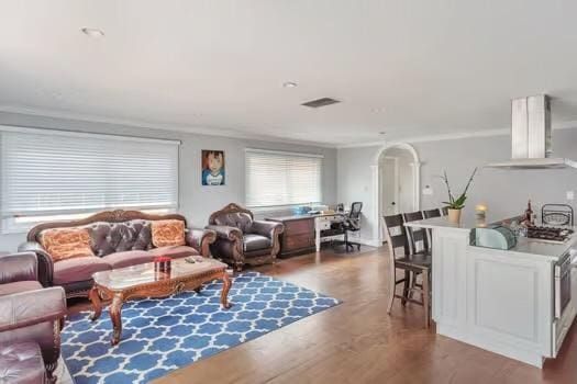 living room with crown molding and hardwood / wood-style flooring