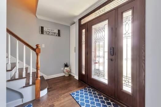 entryway with hardwood / wood-style flooring, a wealth of natural light, and crown molding