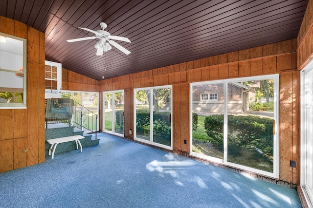 unfurnished sunroom featuring ceiling fan, lofted ceiling, and wood ceiling