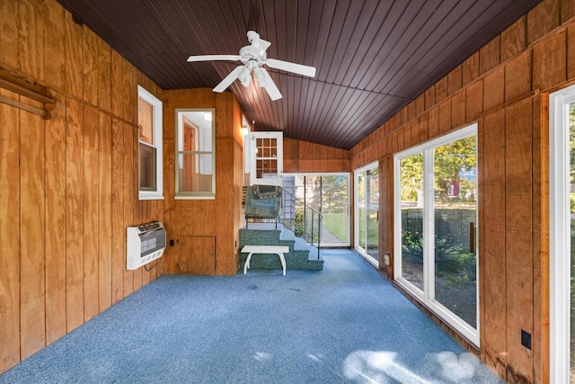 unfurnished sunroom featuring lofted ceiling, ceiling fan, heating unit, and wooden ceiling