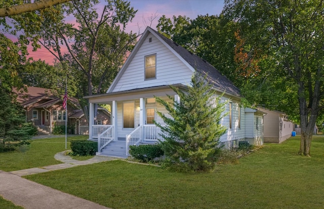 view of front of property featuring a lawn and a porch