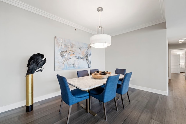 dining room with dark hardwood / wood-style flooring and crown molding