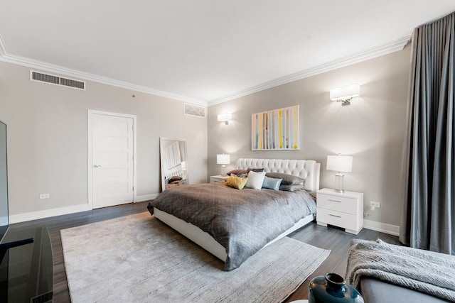 bedroom with crown molding and dark hardwood / wood-style floors